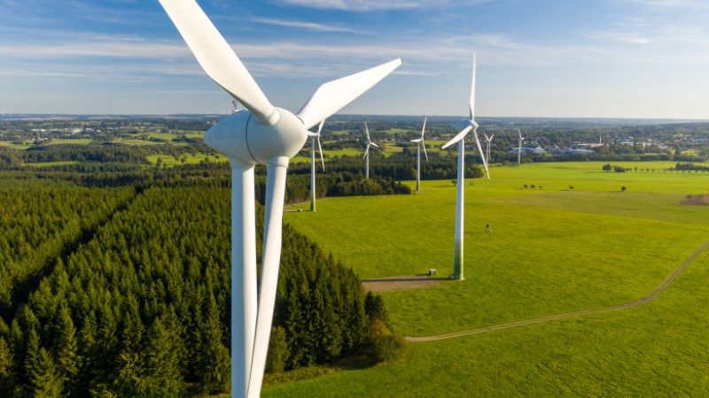 Several large wind turbines on the grassland